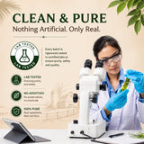 Person in lab coat and goggles holding a leaf next to a microscope with text about product purity.