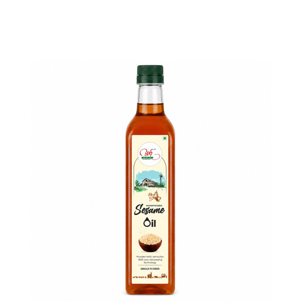 Bottle of sesame oil with a green cap on a white background