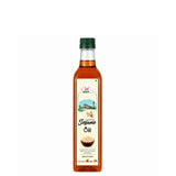 Bottle of sesame oil with a green cap on a white background