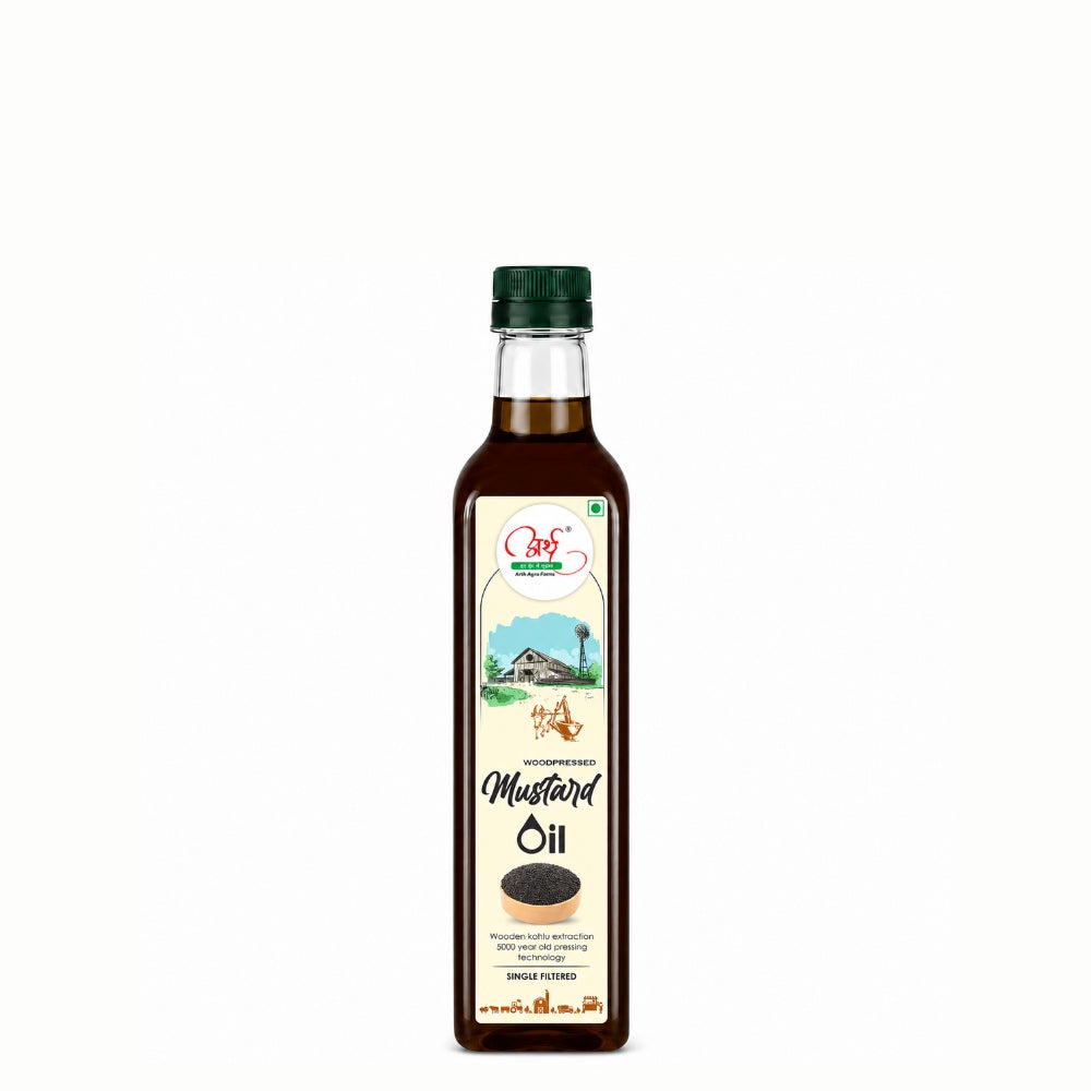 Bottle of mustard oil with a green cap on a white background