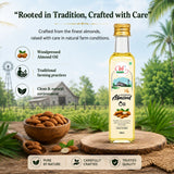 Bottle of woodpressed almond oil with almonds and a wooden spoon on a natural background